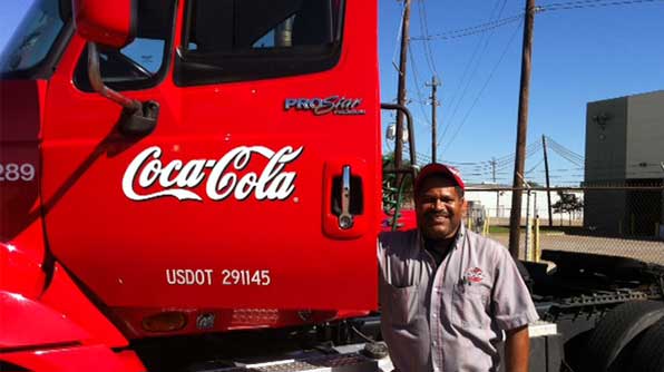 Red Coca-Cola truck and a proud truck driver