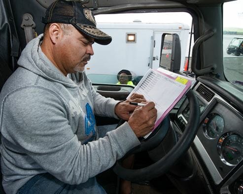 Truck driver filling out forms