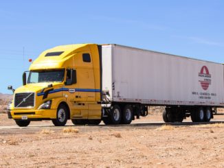 Yellow truck hauling in the desert