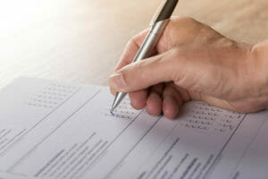 Man filling out multiple-choice CDL written test