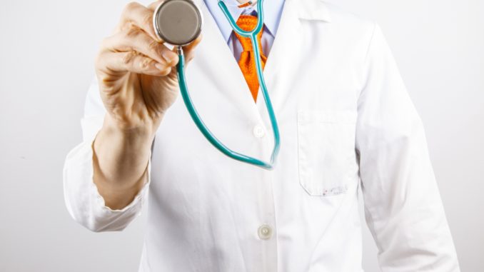 Doctor holding stethoscope for DOT physical