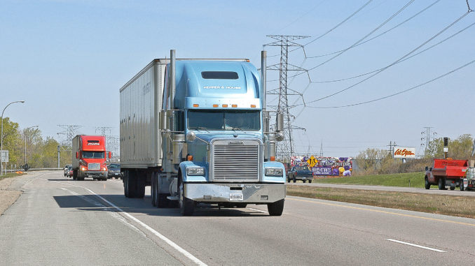 Truck on the move Light blue truck against light blue sky