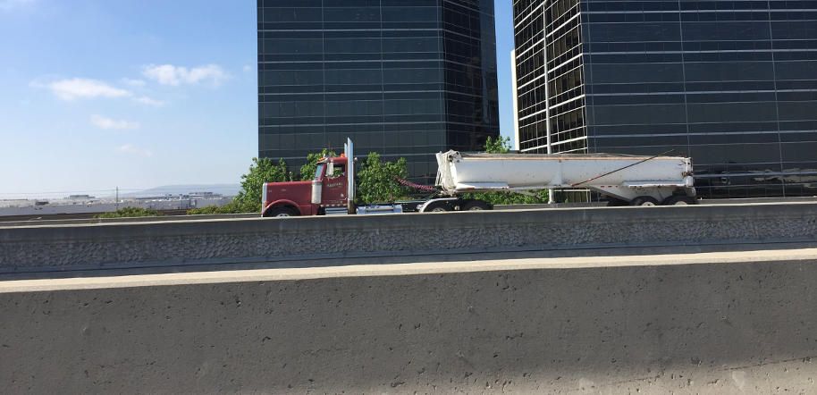 Red truck driving on the highway in Los Angeles