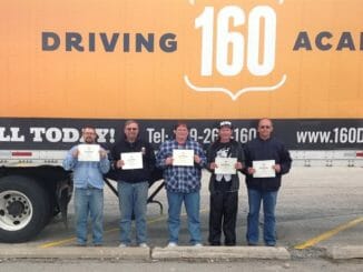 Truck driver students in front of truck with 160 Driving Academy