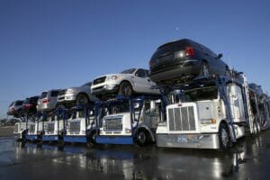Auto-transport trucks lined up with cars