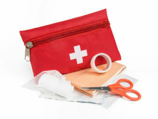 Red first aid kit with scissors and gauze