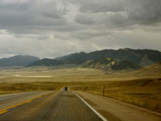 Road in Wyoming stretches to the mountains