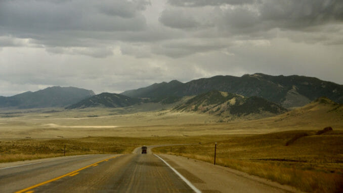 Road in Wyoming stretches to the mountains